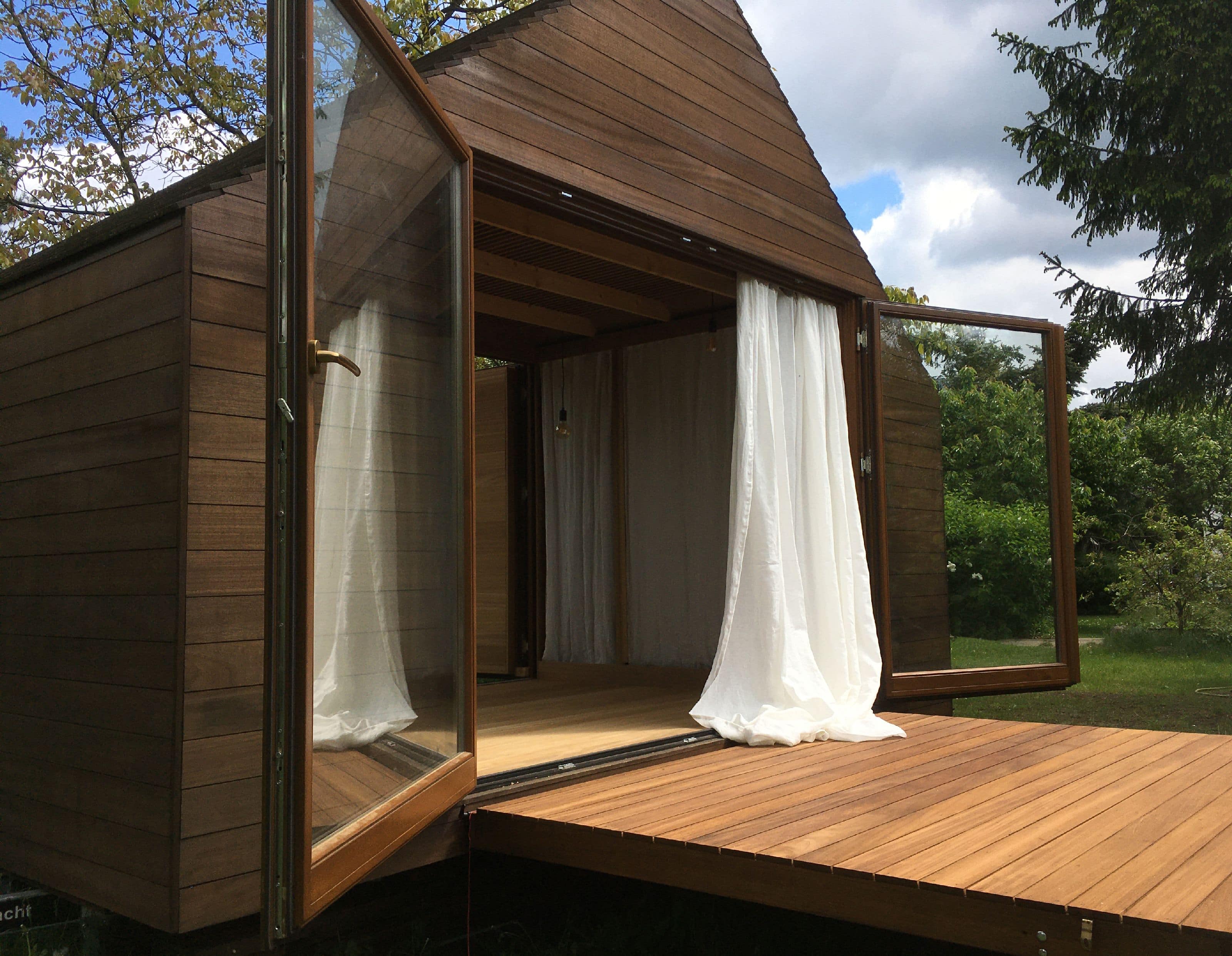 Minimalist wooden modular house, designed with a panoramic view of nature.